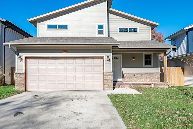 view of front facade featuring a porch, a garage, and a front lawn