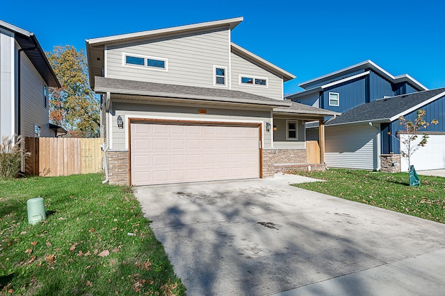 view of front of property with a front yard and a garage