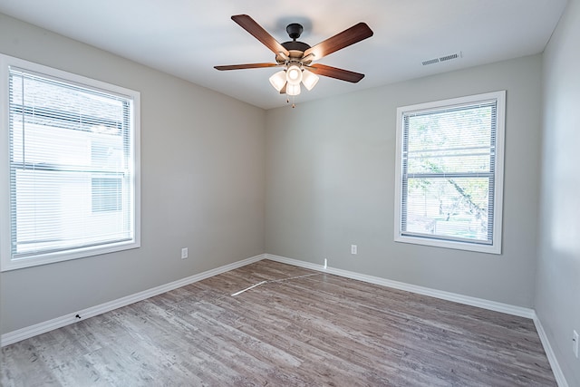 empty room with hardwood / wood-style flooring and ceiling fan