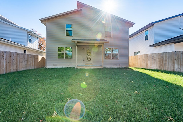 back of house featuring a yard