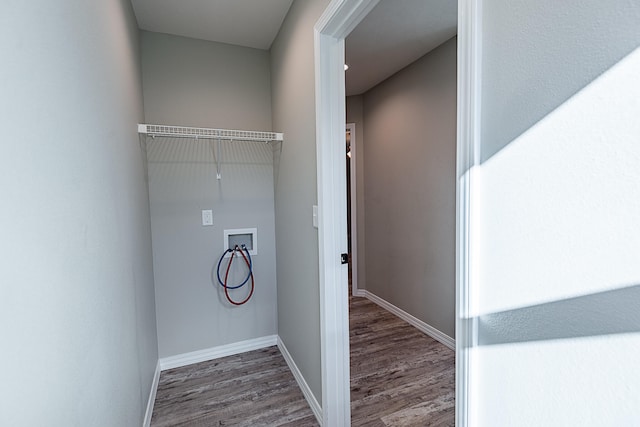 washroom with hookup for a washing machine and hardwood / wood-style flooring