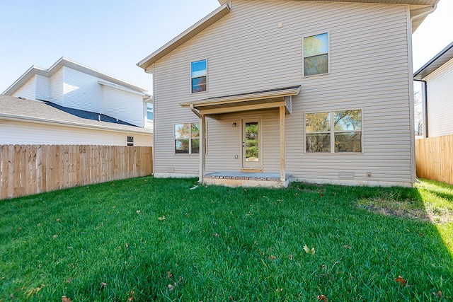 rear view of house with a yard