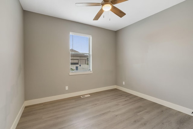 empty room with light hardwood / wood-style flooring and ceiling fan