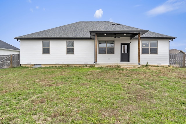 back of property featuring a lawn