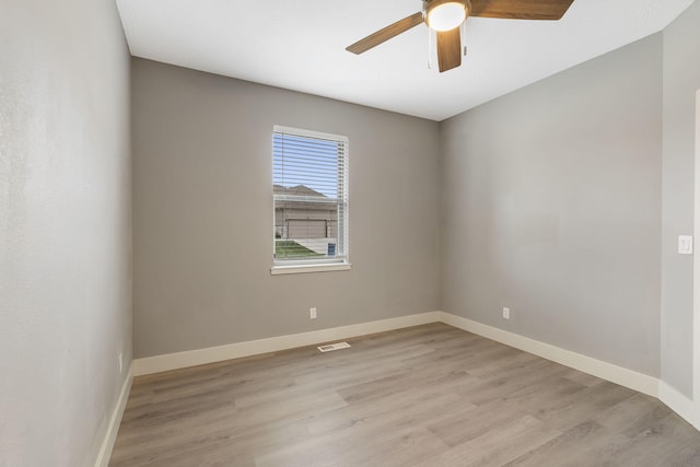 spare room featuring ceiling fan and light wood-type flooring