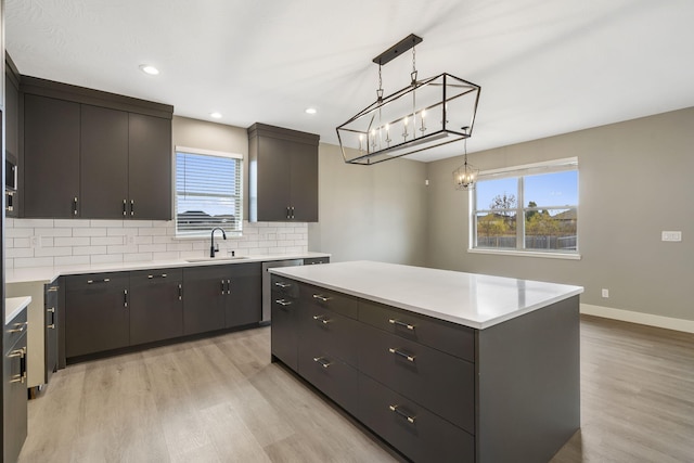 kitchen featuring dark brown cabinets, light hardwood / wood-style flooring, and a kitchen island