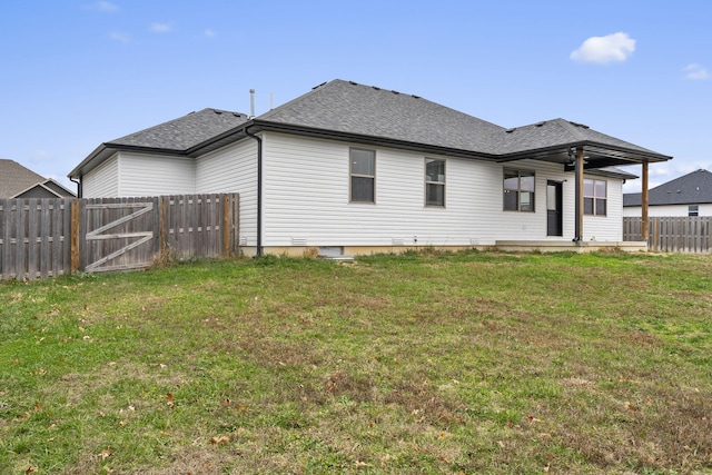 rear view of house with a yard and ceiling fan