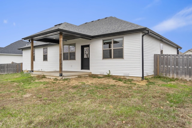 rear view of house with a yard and a wooden deck