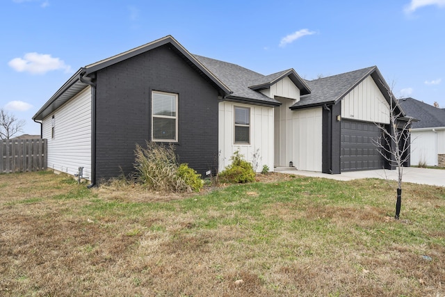 view of front of house with a front yard and a garage