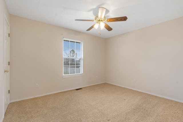 carpeted empty room featuring ceiling fan