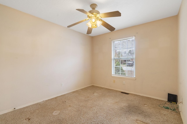 carpeted spare room with ceiling fan