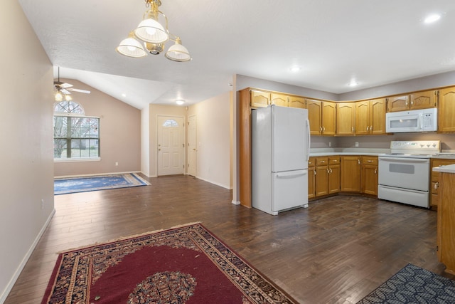 kitchen featuring white appliances, vaulted ceiling, ceiling fan, dark wood-type flooring, and hanging light fixtures