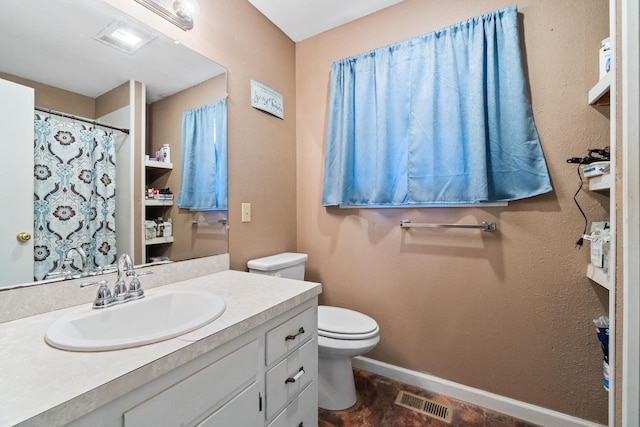 bathroom with tile patterned flooring, vanity, and toilet