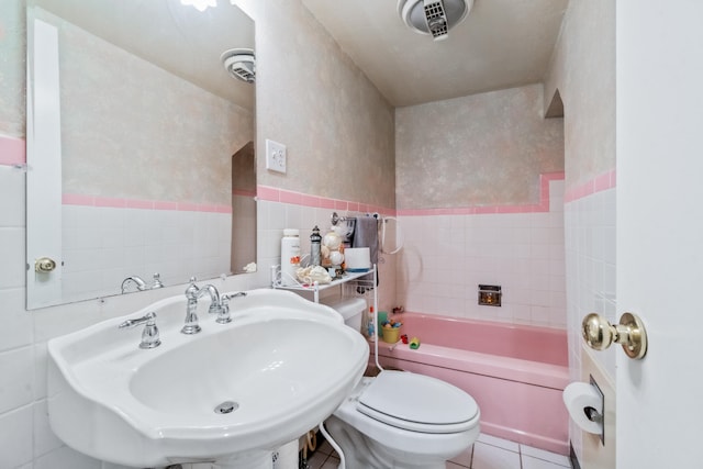 full bathroom with bathing tub / shower combination, sink, tile patterned flooring, toilet, and tile walls