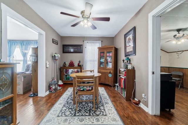 dining room with ceiling fan and dark wood-type flooring