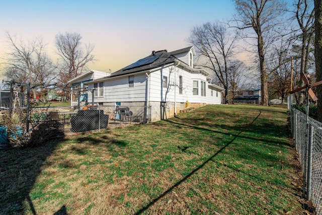 exterior space featuring a lawn and solar panels