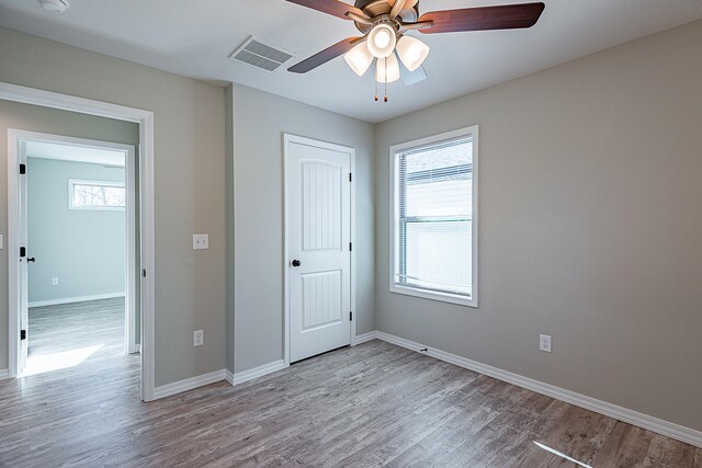 unfurnished bedroom with ceiling fan and light hardwood / wood-style flooring