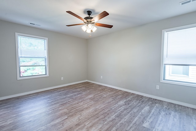 spare room with wood-type flooring and ceiling fan