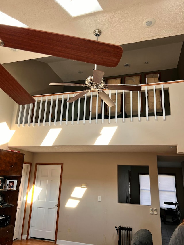 stairway featuring ceiling fan and radiator heating unit