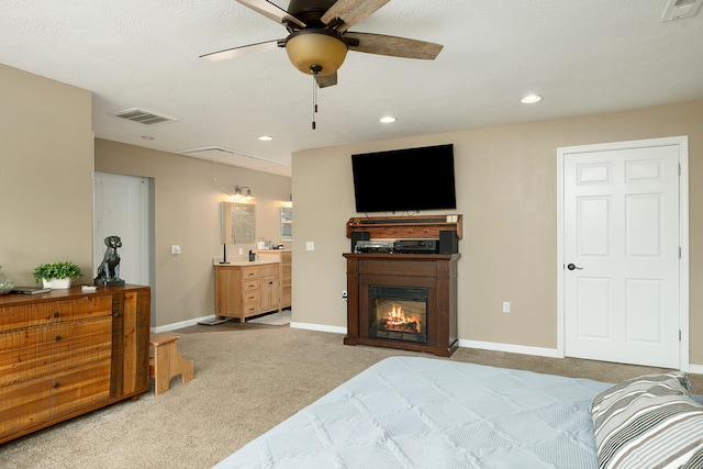 carpeted bedroom featuring a textured ceiling and ceiling fan