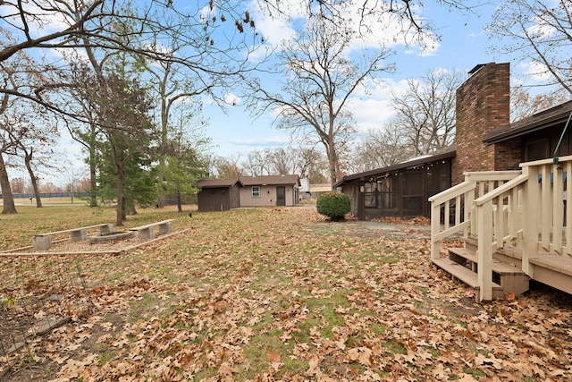 view of yard with an outbuilding and a deck