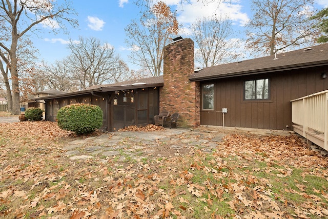 back of property with a sunroom