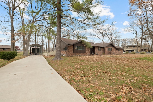 ranch-style home with a carport and a front lawn