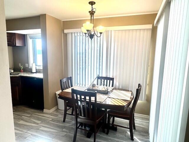 dining area featuring an inviting chandelier and light hardwood / wood-style flooring