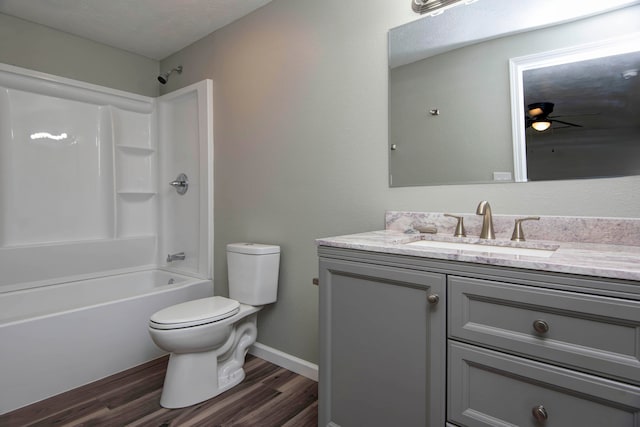 full bathroom with vanity,  shower combination, ceiling fan, hardwood / wood-style floors, and toilet