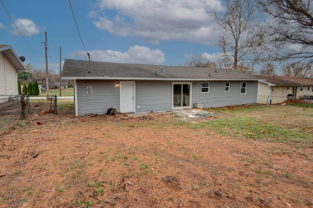 rear view of property with a yard