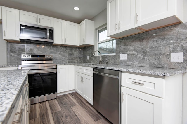 kitchen with white cabinetry, sink, and stainless steel appliances