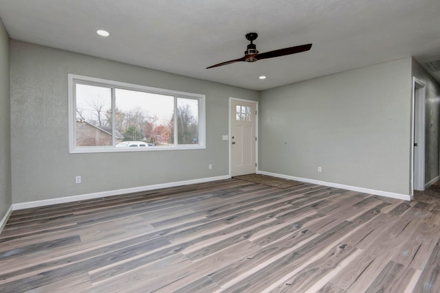 interior space with ceiling fan and hardwood / wood-style floors