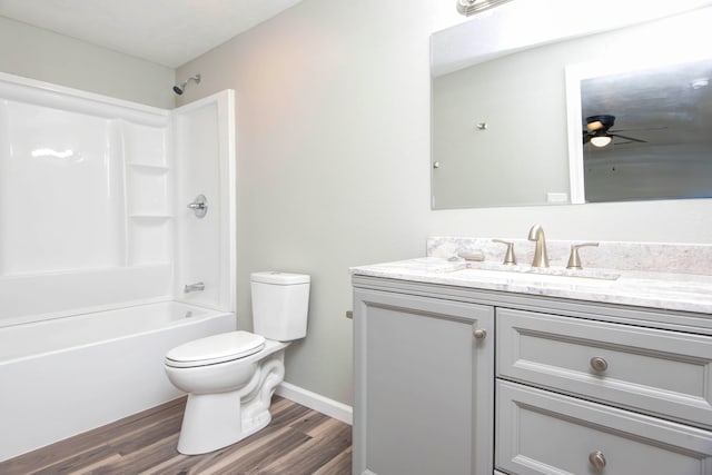 full bathroom with ceiling fan, wood-type flooring,  shower combination, toilet, and vanity