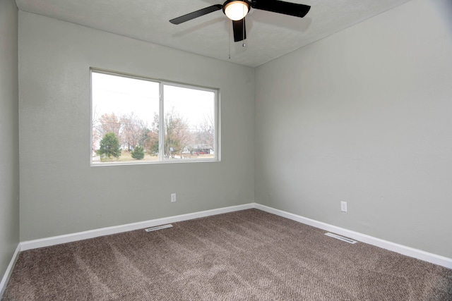 carpeted spare room with a textured ceiling and ceiling fan