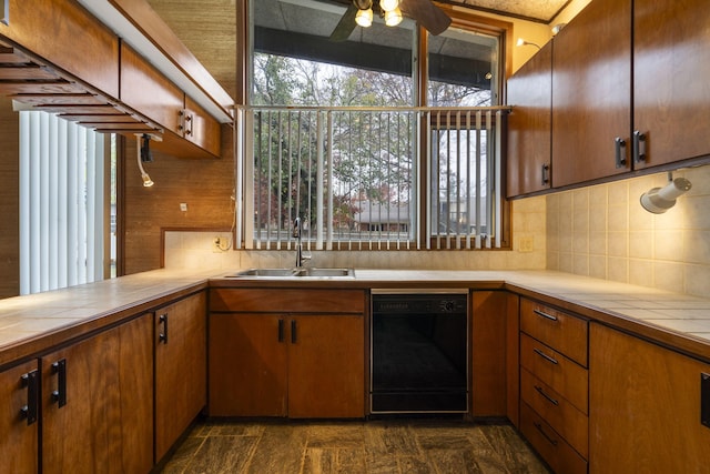 kitchen with ceiling fan, dishwasher, sink, backsplash, and lofted ceiling