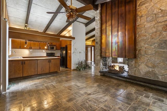 kitchen with backsplash, ceiling fan, sink, black appliances, and beamed ceiling