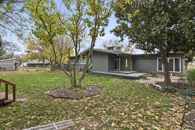 back of house with a yard and a wooden deck