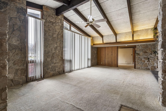 interior space featuring carpet, lofted ceiling with beams, and ceiling fan