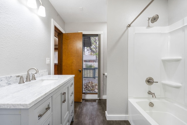 bathroom with wood-type flooring, vanity, and shower / bath combination