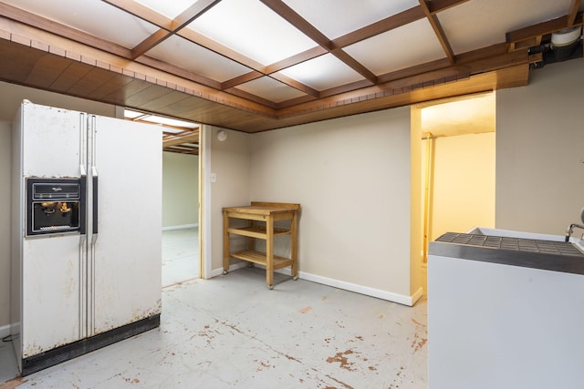 basement featuring white fridge with ice dispenser