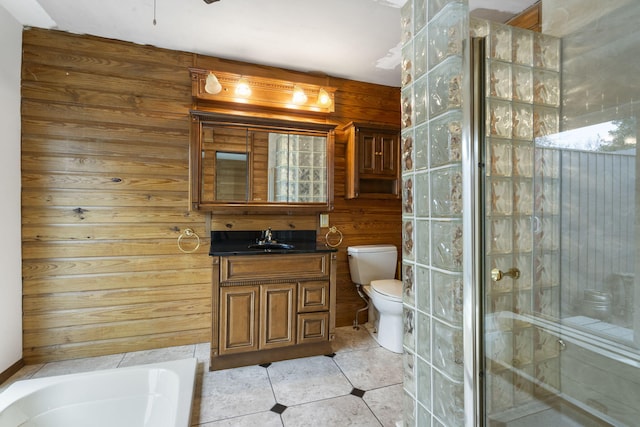 full bathroom featuring tile patterned floors, wooden walls, vanity, and toilet