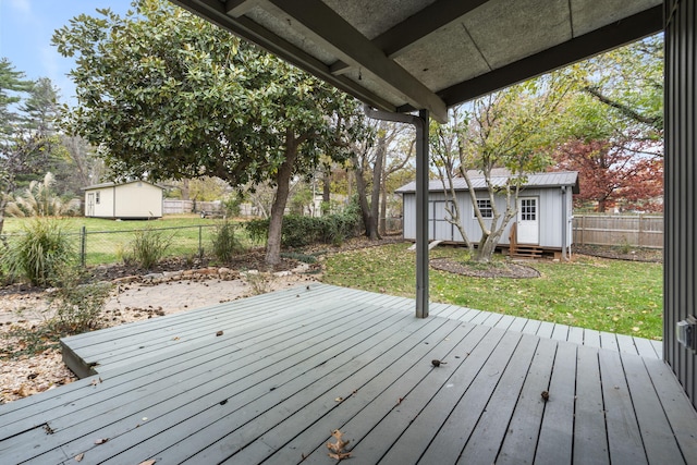 wooden terrace featuring a shed and a yard