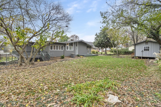 view of yard with a deck, a storage unit, and central air condition unit