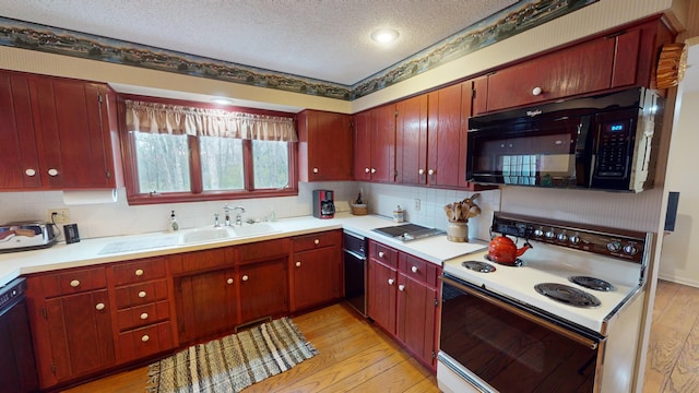 kitchen featuring black appliances, sink, light hardwood / wood-style flooring, decorative backsplash, and a textured ceiling