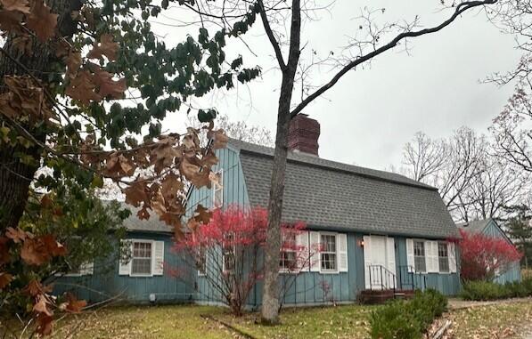 15047 E Peace Rd, Nevada, MO 64772 - view of front of property with a chimney, a gambrel roof, and roof with shingles