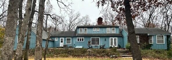 15047 E Peace Rd, Nevada, MO 64772 - rear view of house with a chimney
