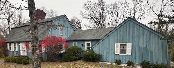 15047 E Peace Rd, Nevada, MO 64772 - view of home's exterior with a chimney and board and batten siding