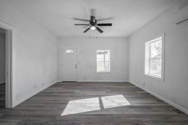 foyer entrance with a wealth of natural light, ceiling fan, and dark wood-type flooring