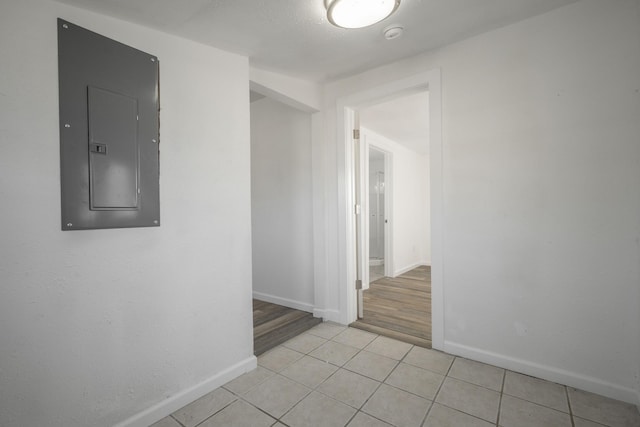 hall featuring electric panel and light hardwood / wood-style floors