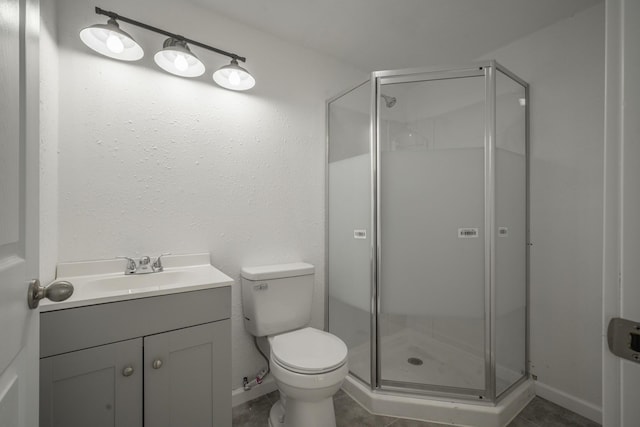 bathroom with tile patterned flooring, a shower with door, vanity, and toilet